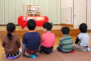 ひな人形に向かって歌をうたう園児たちの画像