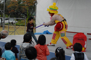 ステージショーでバルーンアートに挑戦する子どもの画像