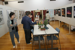 生け花などの展示を見る人たちの画像