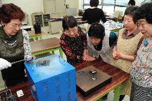 焼きあがった作品を見る参加者の画像